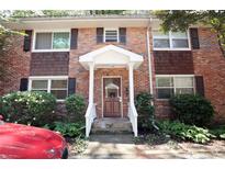 Charming brick townhouse with a covered entryway and well-maintained landscaping at 819 Durant Ne # 819-6, Atlanta, GA 30308