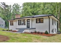 Charming renovated brick home featuring a new roof, stylish black trim, and landscaping at 450 Collier Ridge Nw Dr, Atlanta, GA 30318