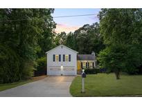 Charming two-story home with a well-manicured lawn, attached two car garage, and lovely landscaping at 4255 Hidden Meadow Circle, Sugar Hill, GA 30518