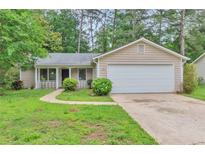 Charming single-story home featuring a well-maintained lawn and attached two-car garage at 744 Martin Rd, Stone Mountain, GA 30088