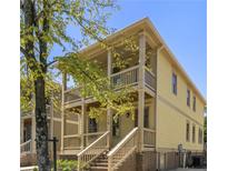 Charming two-story home with a inviting front porch and light yellow siding, showcasing a welcoming curb appeal at 110 Hogue St, Atlanta, GA 30312