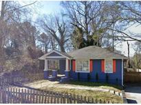 Charming blue bungalow featuring a covered porch and a fenced front yard at 836 Wood Nw St, Atlanta, GA 30318