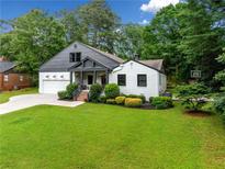Charming home with manicured lawn, lush landscaping, and inviting entryway at 916 Stratford Rd, Avondale Estates, GA 30002