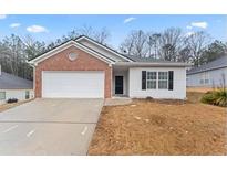 Charming single-story home with a brick facade and a two-car garage at 10231 Deep Creek Pl, Union City, GA 30291