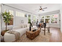 Bright living room featuring large windows, hardwood floors, and a modern sofa at 653 N Highland Ne Ave # 5, Atlanta, GA 30306