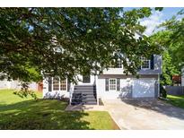 Charming two-story home with gray siding, black shutters, and a well-manicured front yard at 7186 Raintree Loop, Jonesboro, GA 30236