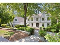 Charming two-story home featuring a well-manicured front yard and a brick exterior at 55 Bransford Rd, Sandy Springs, GA 30324