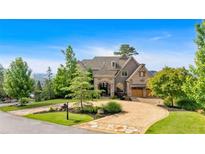 Stunning exterior view of a luxurious home with a circular driveway and beautiful landscaping at 89 Somerset Ln, Cartersville, GA 30121