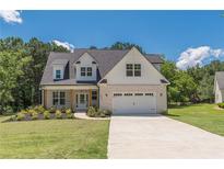 Charming two-story home with a brick and siding facade, well-manicured lawn, and a two-car garage at 4075 O Henry Ct, Mcdonough, GA 30252