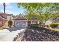 Charming two-story brick home with a well-manicured lawn and two car garage at 436 Crestmont Ln, Canton, GA 30114