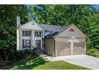 Charming two-story home featuring a two-car garage, well-manicured lawn, and a welcoming front porch at 3006 Durban Ct, Decatur, GA 30034