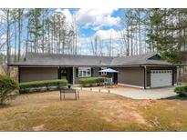 Charming single-story home featuring a well-maintained yard and a two-car attached garage at 2796 County Line Rd, Acworth, GA 30101