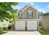 Charming two-story home featuring a two-car garage and neat landscaping, and inviting curb appeal at 3454 Carriage Chase Rd, Atlanta, GA 30349