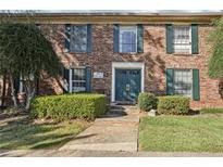 Charming brick apartment building featuring a manicured lawn and inviting front entrance at 5560 Kingsport Ne Dr # 27, Atlanta, GA 30342
