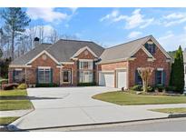 Charming brick home with manicured lawn, two-car garage, and ample driveway space at 4115 Gold Mill Rdg, Canton, GA 30114