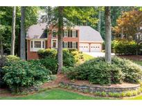 Charming two-story brick home featuring a manicured front yard and an attached two-car garage at 4429 Windsor Oaks Cir, Marietta, GA 30066