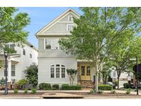 Charming two-story home featuring a shingle and clapboard facade, a welcoming yellow front door and a well-manicured front yard at 169 Waterman Se St, Marietta, GA 30060