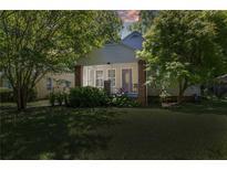 Charming home featuring a screened porch, brick pillars, lovely landscaping and a well-manicured lawn at 1834 Broad Ave, Atlanta, GA 30344