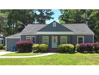 Charming single-story home with gray siding, a covered porch and manicured landscaping at 2437 N Decatur Rd, Decatur, GA 30033
