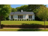 Charming single-story home featuring a well-manicured front yard and classic white exterior at 458 Shannon Sw Dr, Atlanta, GA 30310