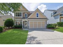 Charming two-story home with a two car garage, well-maintained lawn, and manicured landscaping at 5040 Stonehaven Vw, Cumming, GA 30040