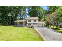 Charming home featuring a lush front lawn and a two-car attached garage at 919 Rock Oak Ln, Lawrenceville, GA 30046