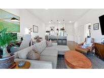 Open living space with modern kitchen, sleek island, and comfortable seating area featuring contemporary decor and hardwood floors at 112 Rogers Street Northeast Ne St # 410, Atlanta, GA 30317