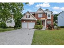 Charming brick home with a two-car garage, landscaped front yard, and inviting entrance at 2988 Belfaire Lake Dr, Dacula, GA 30019