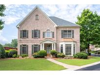 Charming two-story brick home with manicured lawn, dark shutters, and inviting entryway at 3519 Preserve Se Dr, Atlanta, GA 30339