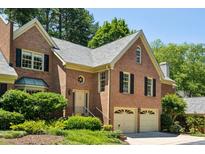 Charming two-story brick home with well-manicured landscaping and a two-car garage at 51 Ivy Chase Ne, Atlanta, GA 30342