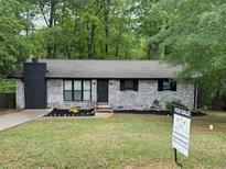 Charming, freshly painted, one-story home with manicured lawn and flower beds in a desirable location at 7994 Devonshire Dr, Jonesboro, GA 30238