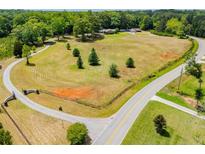 A vast, expansive, aerial view of the property, featuring mature trees, landscaping, and a long, private driveway at 1050 Denton Rd, Douglasville, GA 30134