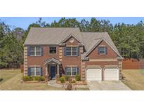 Beautiful two-story brick home with a two-car garage and meticulously kept landscaping at 403 Sonja Ln, Loganville, GA 30052