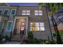 Charming brick two-story home with manicured landscaping and inviting front entrance at 710 Elmwood Way, Roswell, GA 30075