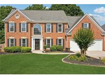 Traditional two-story brick home with a well-manicured lawn and a two car attached garage at 75 Hunters Ct, Dallas, GA 30157