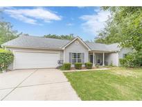 Charming single-story home with a well-maintained lawn and attached two-car garage in a quiet neighborhood at 123 Chippewa Run, Auburn, GA 30011