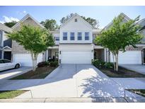 Inviting townhome with a well-maintained front yard and a two-car garage at 128 Madison Bnd, Woodstock, GA 30188