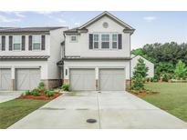 Charming two-story townhouse with a two-car garage and well-maintained landscaping at 3848 Hester St, Duluth, GA 30097