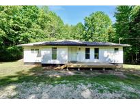 Charming single-story home featuring a front deck and surrounded by lush greenery at 4289 Post Rd, Winston, GA 30187