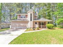 Charming two-story home with a unique tower entrance and a well-maintained front yard at 916 Forest Pointe Way, Jonesboro, GA 30238