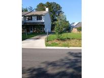 Charming two-story home with vinyl siding, a driveway, and a partially fenced yard at 3503 Ten Oaks Court Ct, Powder Springs, GA 30127