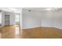Spacious living room featuring hardwood floors and contemporary lighting at 199 14Th Ne St # 402, Atlanta, GA 30309