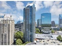 Stunning view of a modern high-rise building with curved architecture and glass facade at 3338 Peachtree Ne Rd # 508, Atlanta, GA 30326