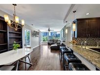 Spacious living room featuring modern decor, a chandelier, hardwood floors, and city views at 3338 Peachtree Ne Rd # 508, Atlanta, GA 30326