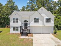 Charming two-story home with a well-maintained lawn, front-facing garage and classic curb appeal at 3156 Ozmer Lndg, Decatur, GA 30034