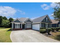Charming single-story home with a well-manicured lawn, complemented by a spacious driveway and an attached garage at 3634 Cape Ln, Conyers, GA 30013