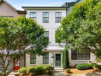 Charming two-story white brick home with lush green landscaping and large windows at 752 Winton Way, Atlanta, GA 30312