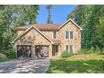 Charming stone-clad home with a two-car garage and well-maintained landscaping at 3005 Park Chase, Alpharetta, GA 30022