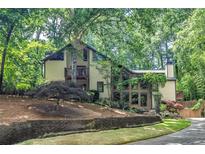 Two-story home with a lush, wooded lot and mature landscaping for ultimate privacy and curb appeal at 4655 Latimer Ne Ct, Kennesaw, GA 30144