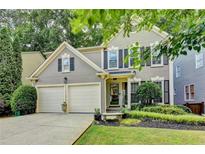 Charming two-story home with a well-manicured front yard and a two-car garage at 10000 Barston Ct, Johns Creek, GA 30022